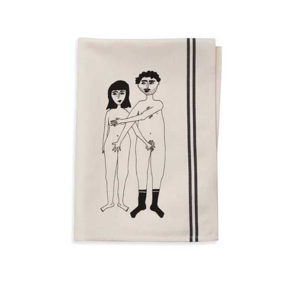 The Couple Tea Towel – Front is a beige kitchen towel with curated Estonian design, showing two nude figures—one shielding both—plus two thin black stripes along the right edge, adding a unique touch to modern kitchens. Gate21.ee