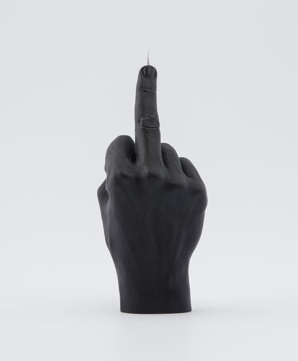 The F*ck You Candle - Black is a candle shaped like a human hand giving the middle finger, shown on a white background—ideal for concept shop displays or anyone looking for unique finds whilst shopping in Tallinn. Gate21.ee