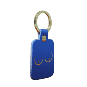 A black rectangular keyring with a gold ring, featuring a minimalist line drawing of breasts on one side—a unique Boob Key Ring and standout piece of curated Estonian design for Tallinn shopping lovers. Gate21.ee