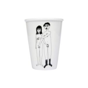 The Couple Cup - Front is a white mug from a concept shop, featuring a black line drawing of a nude man (in socks, arm around the long-haired woman) and woman standing side by side—a unique gift shop addition. Gate21.ee