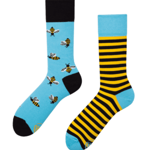 Bee Bee features two mismatched socks: one blue with cartoon bees and black heel and toe, the other blue with black and yellow stripes—adding a playful touch to any look. Perfect for concept shops or gift shops. Gate21.ee