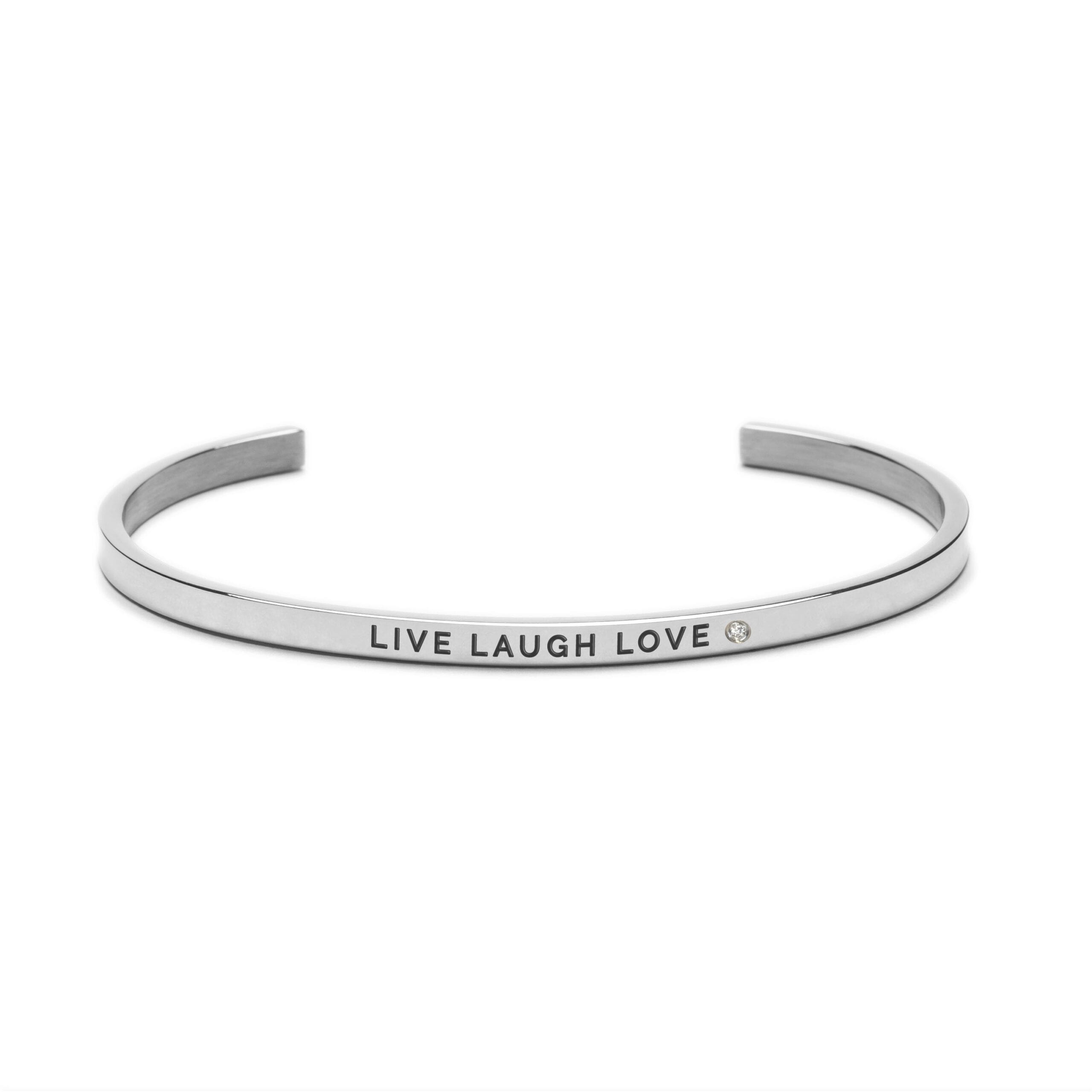 The Live Laugh Love silver cuff bracelet features an engraved message and a small round gem, making it an elegant gift shop find for style lovers. Presented against a white background. Gate21.ee