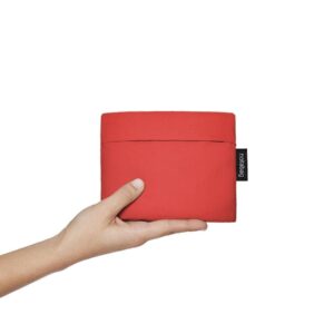 A hand holds the Red pouch, a small rectangular bag with a black side tag, against a white background—ideal for unique curated gift shop finds. Gate21.ee