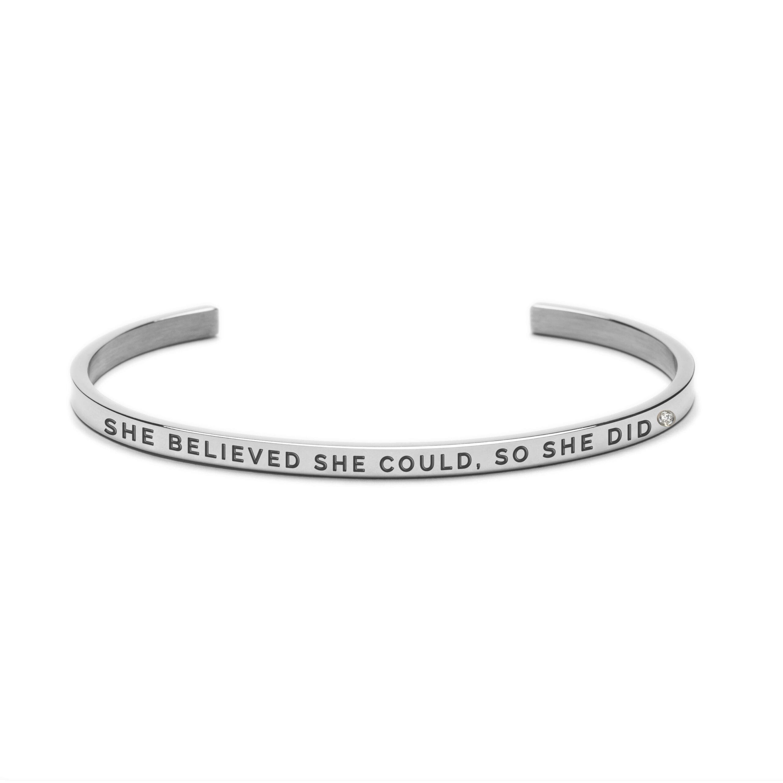 The "She believed She could so She did" bracelet is a silver open cuff engraved in uppercase. Inspired by Estonian design, this plain elegant piece sits beautifully against a white background. Gate21.ee
