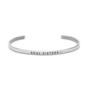 A thin, silver cuff bracelet with the words SOUL SISTERS engraved on the outside, featuring a small circular gem beside the text—an elegant piece of curated Estonian design. Gate21.ee