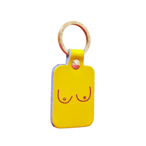 The Boob Key Ring - Yellow is a rectangular keyring with a metal ring and a minimalist line drawing of two breasts on the front. Its playful design makes it an eye-catching addition to any set of keys or concept shop collection. Plain white background. Gate21.ee