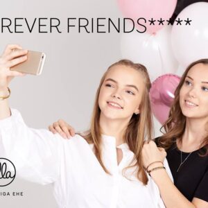 Two young women smile and take a selfie in front of pink and white balloons. "FOREVER FRIENDS" appears in large text, with the olla SÕNUMIGA EHE logo in the lower left corner—your shop for unique gifts. Gate21.ee