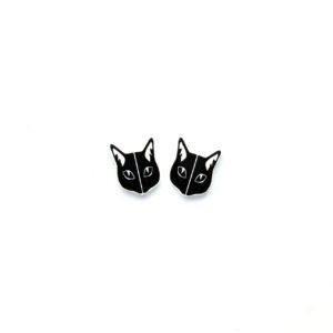 Two small, black, cat-shaped earrings with white accents are placed side by side on a plain white background—an example of Estonian design that makes for unique ideas when exploring Tallinn shopping. Gate21.ee