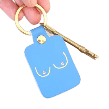 A hand holds the Boob Key Ring - Mint, featuring curated Estonian design: a minimalist line drawing of two breasts with pink nipples—perfect for those seeking unique Tallinn shopping finds. Gate21.ee