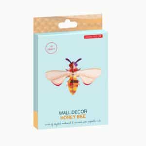 A rectangular package labelled "Honey Bee" showcases a colourful, geometric bee design. Made of recycled cardboard and printed with vegetable inks, it's a 3D wall decor ideal for concept shops or unique Tallinn shopping finds. Gate21.ee