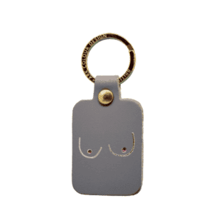 The Boob Key Ring - Grey is a rectangular leather keyring with a gold metal ring and minimalist breast line art—ideal for concept shop fans or anyone hunting for unique Tallinn gifts. Gate21.ee