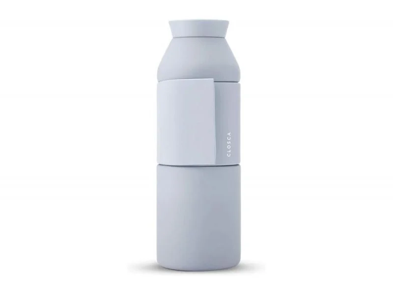 The Closca Wave - Antarctica is a minimalist, matte light grey reusable bottle with a cylindrical shape and flat handle; its vertical CLOSCA branding stands out, making it an ideal find at a Tallinn concept shop. Gate21.ee