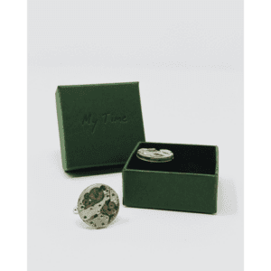 Clock Cufflinks are displayed in front of a green box with "My Time" embossed on the lid; one cufflink rests inside the open box with a black interior, curated for modern gift shops or concept stores. Gate21.ee