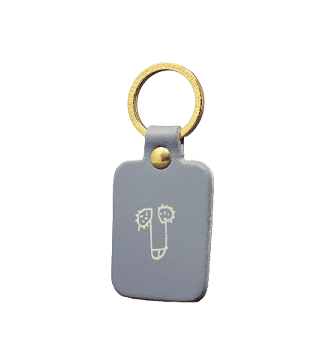 The Dick Key Ring - Grey features a rectangular light grey design with a gold metal ring and two smiling cartoon faces—ideal as a quirky souvenir from Tallinn or a unique find at your favourite concept store. Gate21.ee