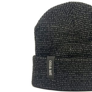 The Reflective Unisex Beanie - Black features a black and white knitted design with a turned-up brim, accented by a small black oma.asi tag&mdash;ideal as a standout gift from a Tallinn shopping destination. Shown against a white background. Gate21.ee