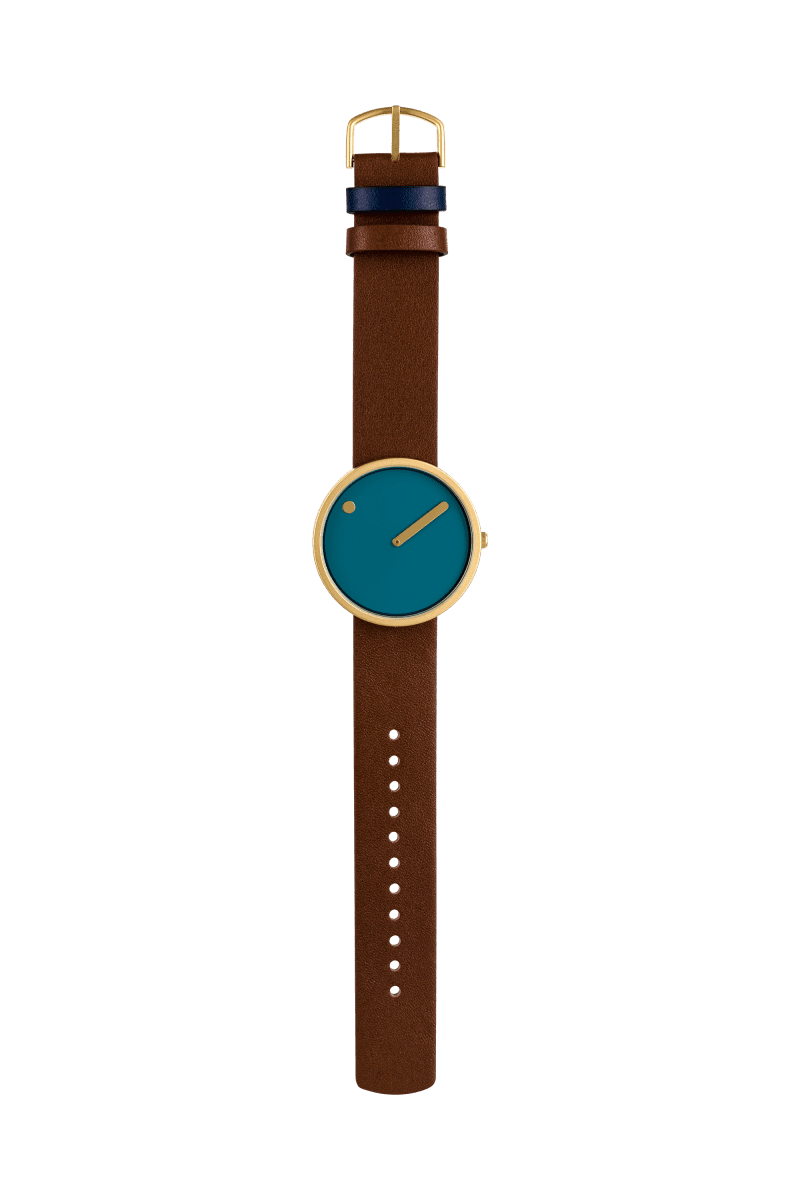 The Dusty Blue / Gold / 40mm wristwatch features a round gold case, teal blue face with minimal markings, single angled hand, and a brown leather strap with blue and black loops plus gold buckle. Ideal for any concept shop. Plain white background. Gate21.ee
