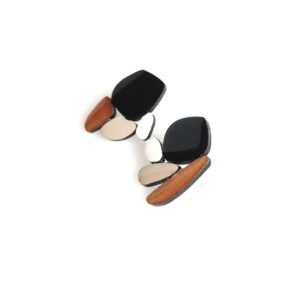 A pair of asymmetrical earrings featuring black, beige, and white geometric shapes with a wooden accent—an excellent example of Estonian design, perfect for those seeking unique finds in Tallinn shopping or a gift shop. Gate21.ee