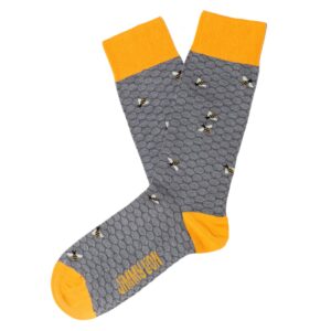 A pair of grey socks with a honeycomb pattern, yellow toes, heels, and cuffs, featuring small bee illustrations and the words “HONEY HOP” on the sole—a charming example of unique ideas in Estonian design. Gate21.ee