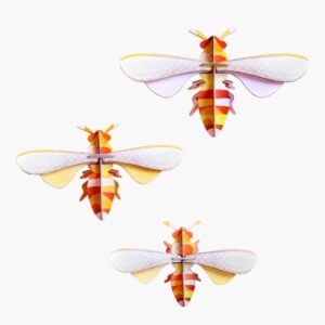Three curated paper craft bees with orange, yellow, and white striped bodies and pale translucent wings are arranged on a plain white background, reflecting playful Estonian design. Gate21.ee