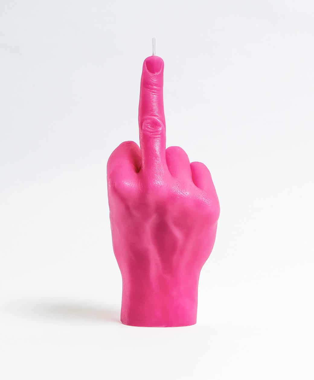 The F*ck You Candle - Pink is a bright pink candle shaped like a human hand with the middle finger raised, featuring Estonian design, displayed against a plain white background. Gate21.ee