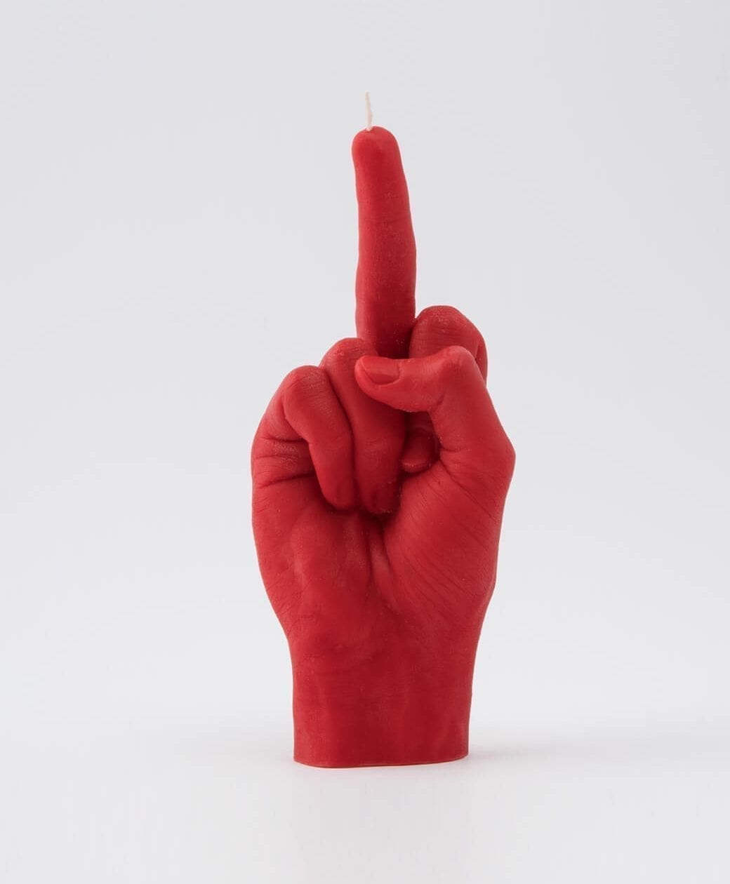 The F*ck You Candle - Red is a bold red candle shaped as a hand giving the middle finger, styled for Estonian design lovers and ideal for gift shop seekers wanting something unique. Gate21.ee