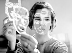 A person holds the Circles on the Water - Silver, its wire design casting abstract face patterns in black and white&mdash;a striking scene and a perfect inspiration for those seeking unique gifts from Tallinn&rsquo;s distinctive shops. Gate21.ee