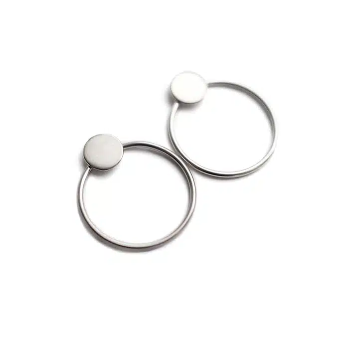 Circles on the Water - Silver: Minimalist silver hoop earrings with small circular studs, inspired by Estonian design, displayed on a white background. Gate21.ee