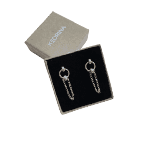 A pair of Insomnia - Small - Round Silver hoop earrings with double chain accents displayed in a black velvet-lined box, branded KEDRINA on the lid—a chic find from a Tallinn shopping concept shop. Gate21.ee