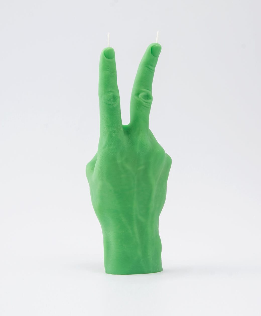 The Peace Candle - Green is a hand-shaped candle making a peace sign, with two wicks at the raised fingers—an ideal Tallinn gift or fun decor piece, photographed against a plain white background. Gate21.ee