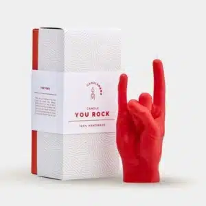 A bold red "Let's Rock - Red" candle, shaped like a hand making the rock on sign, sits beside its stylish box reading "CANDLEHAND CANDLE YOU ROCK 100% HANDMADE"—ideal for concept shops or gift shops seeking standout pieces. Gate21.ee