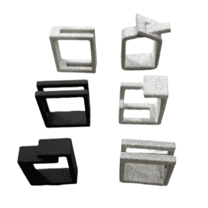 Six black and grey geometric objects&mdash;part of the Ring - DUALITY - K&Otilde;IK collection&mdash;are arranged in two rows on a white background. A grey piece features an arrow motif, showcasing inventive Estonian design. Gate21.ee