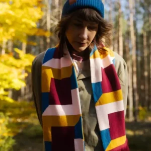 A person wearing Chain - Organic stands outdoors in a sunlit forest with yellow foliage—perfect inspiration for curated Tallinn shopping or unique autumn style ideas. Gate21.ee