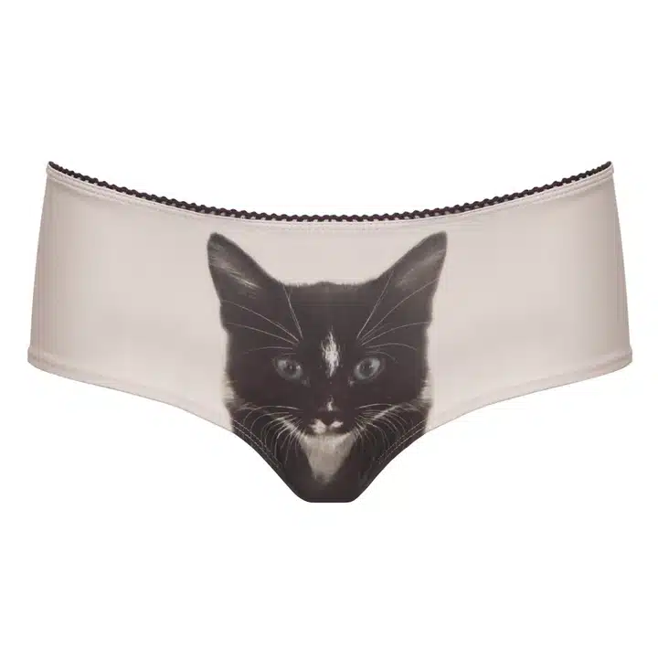 A pair of beige knickers featuring a realistic print of a black and white cat’s face on the front, inspired by playful Estonian design—perfect for those who love unique, curated finds. Gate21.ee