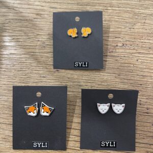 Three pairs of SYLI earrings are shown on black cards, showcasing stylish Estonian design. Ideal for Tallinn shopping or as a special gift shop find. Gate21.ee