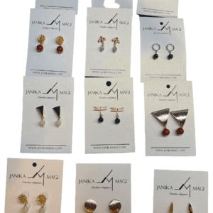 Twelve pairs of Janika Magi K&otilde;rvar&otilde;ngad are displayed on white branded cards, featuring curated Estonian design in various styles, shapes, and colours with gold, silver, blue, green, and red accents. Gate21.ee