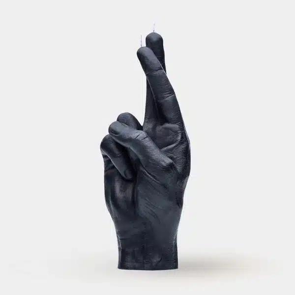A purple candle shaped like a human hand showing the middle finger, with wicks at the fingertips. The F*ck You Candle is a bold Estonian design—an unforgettable Tallinn shopping find or unique present. Set against a plain, light background. Gate21.ee