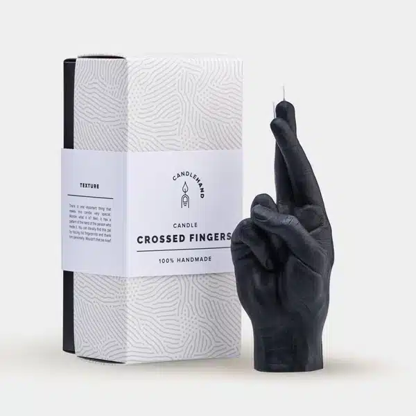 A bold purple candle shaped like a hand showing the middle finger stands beside a white, textured box labelled F*ck You Candle—a distinctive piece of Estonian design ideal for Tallinn shopping or any modern concept shop. Gate21.ee