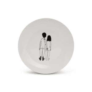The Helen B Plates - KÕIK is a white ceramic plate featuring a minimalist black line drawing of a standing couple holding hands, viewed from behind—an ideal addition to your Tallinn shopping finds. Gate21.ee