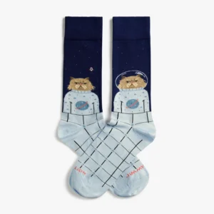 A pair of Jimmy Lion Space Cat - Regular socks featuring illustrations of grumpy cats dressed as astronauts against a dark blue space background, with LION and JIMMY printed in red on the toes. Gate21.ee