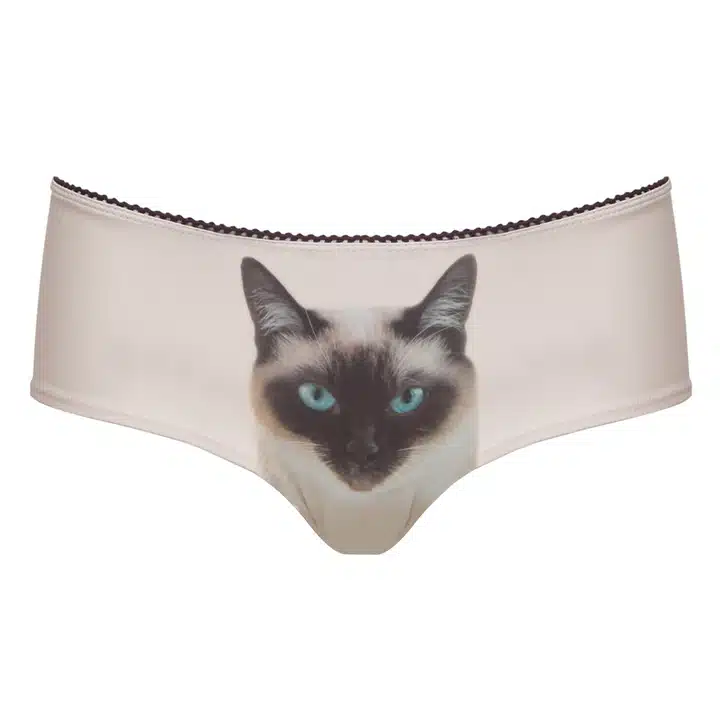Siamese Cat Knickers: Beige women’s underwear with a blue-eyed Siamese cat face at the centre, inspired by Estonian design. A distinctive addition for concept shops or gift shops. Gate21.ee
