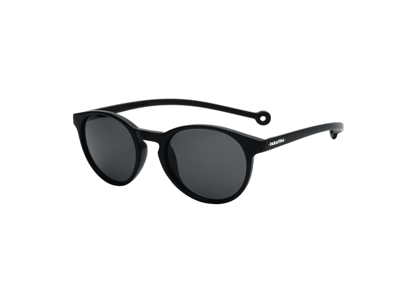 A pair of "Isla" Black Sunglasses with round frames, dark lenses, and flexible arms. Each temple features a small loop and the HAWKERS brand printed in white, inspired by quirky gift shop designs. Gate21.ee