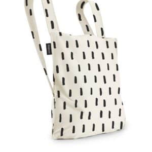 The Black Brush is a cream tote bag with bold black dash patterns, two handles, and a small black tag—perfect for carrying your essentials from your favourite concept shop or whilst shopping in Tallinn. Gate21.ee