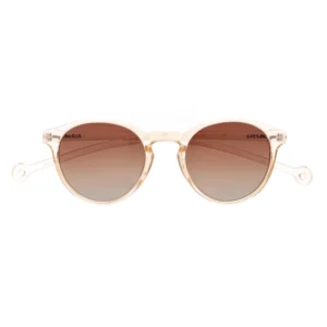 A pair of "Isla" Transparent Nude Sunglasses with round, translucent beige frames and brown gradient lenses, displayed facing forwards on a white background. Gate21.ee