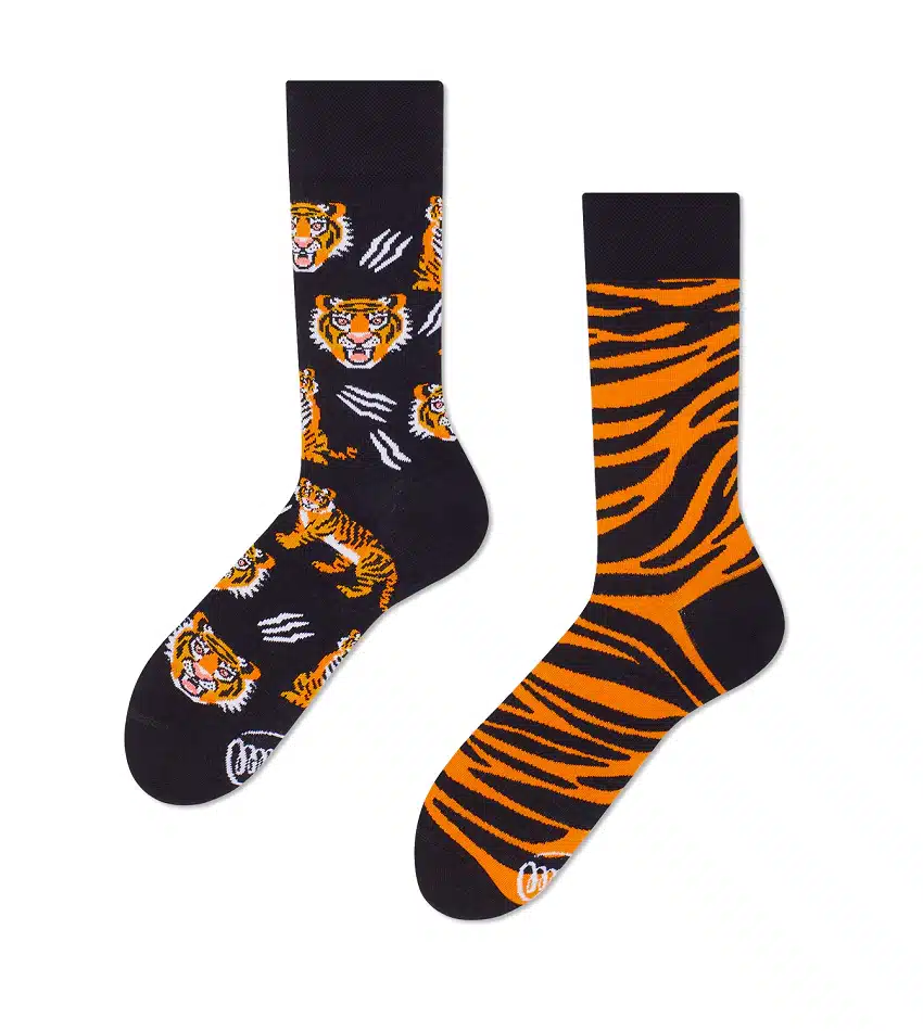 Feet of the Tiger is a mismatched sock pair inspired by Estonian design—one black with orange tigers and white scratch marks, the other with orange and black tiger stripes. A quirky gift from Tallinn or your local shop!. Gate21.ee