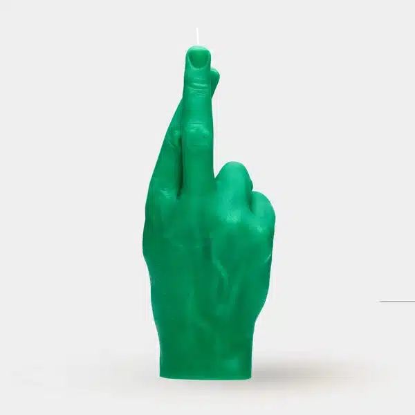 Fingers Crossed - Green: A green candle shaped like a human hand with crossed index and middle fingers, standing upright on a white background—ideal for adding unique flair to any gift shop or concept store. Gate21.ee