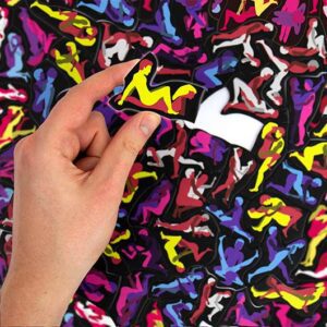 A hand places a piece onto the F*cking Hard Puzzle, featuring vibrant yellow and pink silhouettes—an eye-catching challenge that's perfect for any gift shop celebrating bold Estonian design. Gate21.ee
