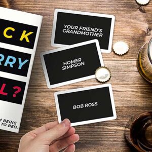 A hand holds an F'ck Marry Kill - Card Game card above a wooden table scattered with drinks, bottle tops, and other cards—great for sparking unique ideas on your next Tallinn shopping or gift shop adventure. Gate21.ee