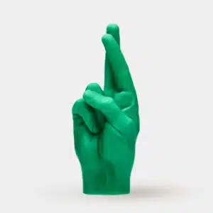 Fingers Crossed - Green: a unique candle shaped like a human hand with crossed fingers, inspired by Estonian design and perfect for concept shops or gift shops. Stands upright against a plain white background. Gate21.ee