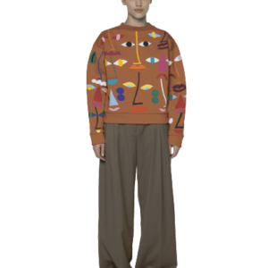 A person stands facing forwards, wearing a Khaki/Green - Pusa sweatshirt with colourful abstract shapes and faces, wide-legged brown trousers, and black shoes. The plain light background offers fresh Tallinn shopping style inspiration. Gate21.ee
