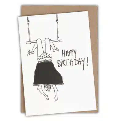The Helen B Greeting Card - KÕIK features a black and white illustration of a person hanging from a trapeze, with "HAPPY BIRTHDAY!" in bold—an ideal birthday card to gift or discover at your favourite Tallinn concept store. Gate21.ee